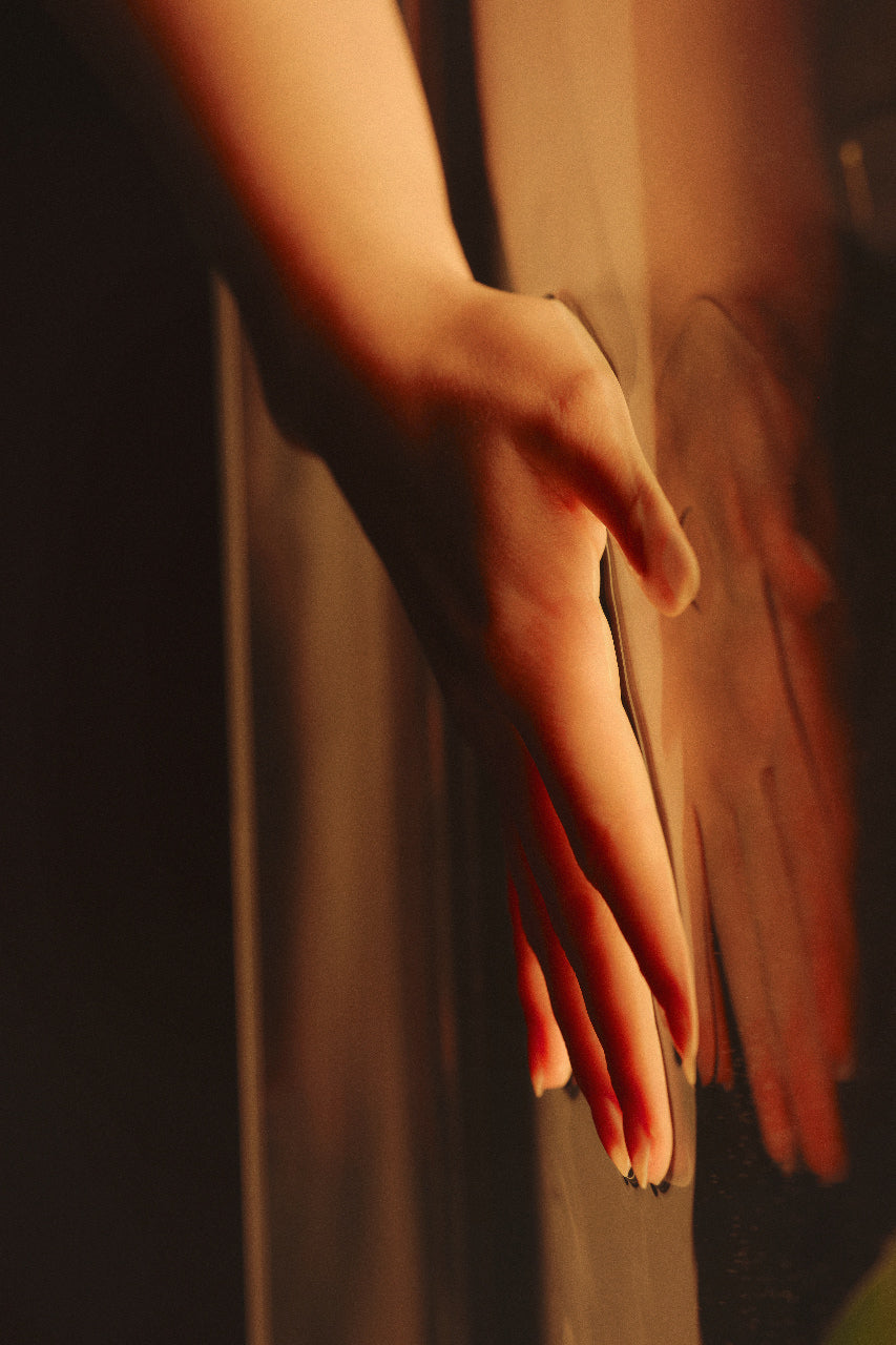 Hand resting during a relaxing full-body Brazilian lymphatic drainage spa treatment at Skincuress
