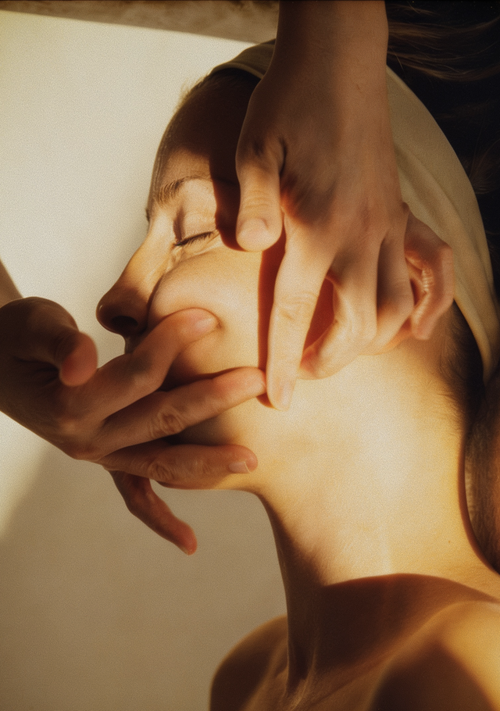 Close-up of a woman receiving a relaxing facial massage during the Buccal & Glow treatment at Skincuress in Hoboken, NJ