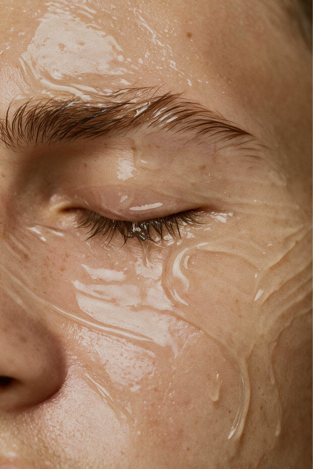 Close-up of glowing, hydrated skin with serum applied near the eye, showcasing the radiant results of the Buccal & Glow facial at Skincuress in Hoboken, NJ