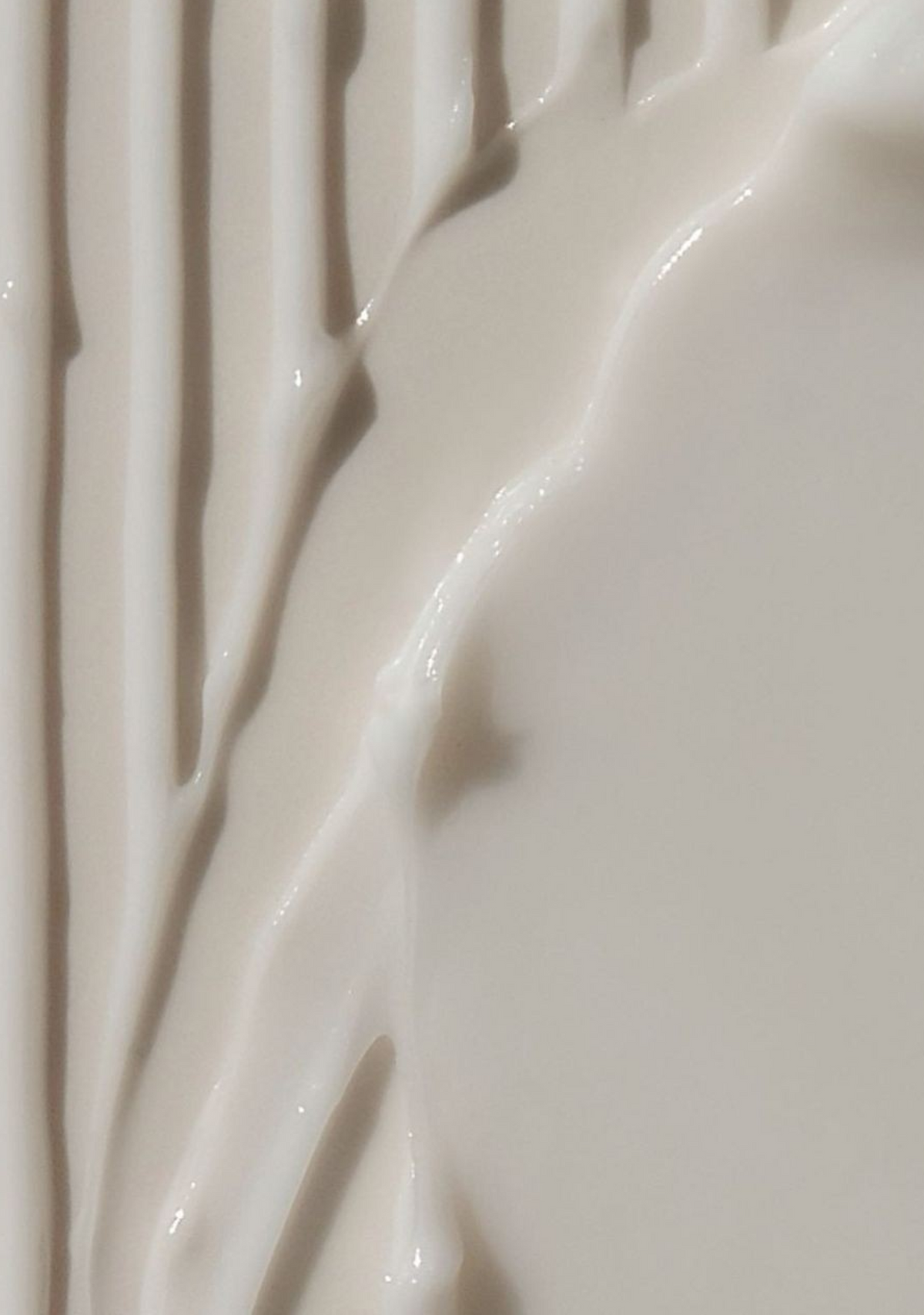 Close-up of thick, creamy skincare product texture with smooth ridges, used in Skincuress's In Residence at-home facial in Hoboken, NJ