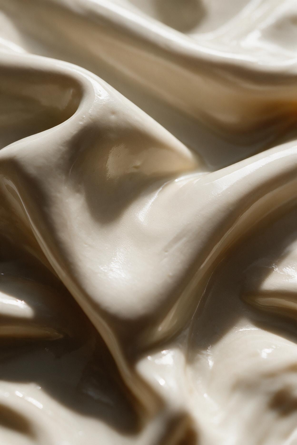 Close-up of creamy mask texture with swirling folds, used in the Signature Skincuress Facial in Hoboken, NJ