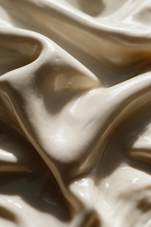 Close-up of creamy mask texture with swirling folds, used in the Signature Skincuress Facial in Hoboken, NJ